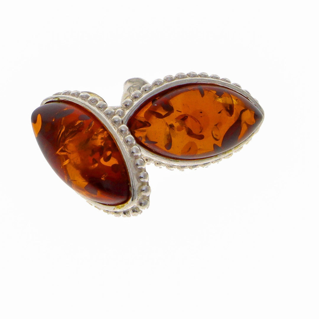 These exquisitely crafted Sterling Silver 925 stud earrings evoke the opulent grandeur of Baroque and Rococo-inspired aesthetics. Each piece showcases a captivating Nordic natural amber cabochon in a warm honey or cognac hue, harmoniously set within an intricately filigreed bezel featuring swirling scrollwork motifs.