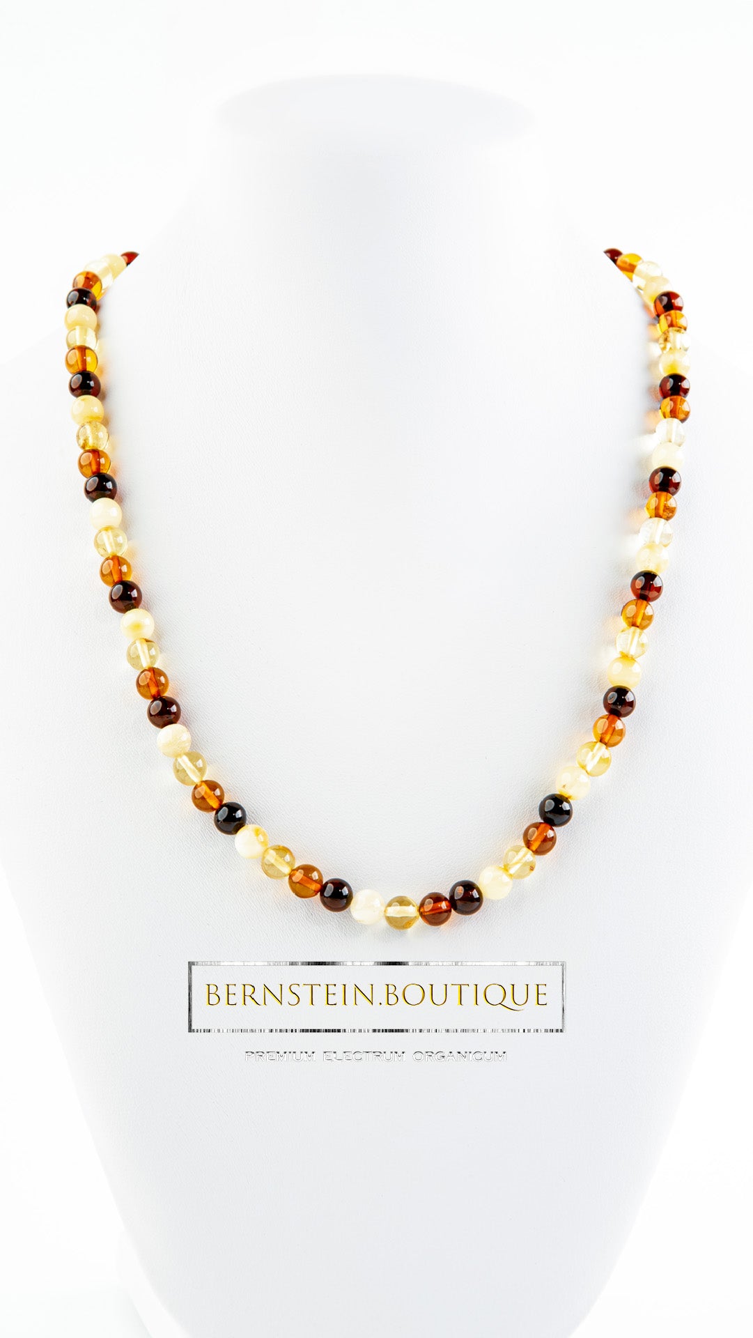 Necklace made of multicolored, polished, round "pearls" of natural amber