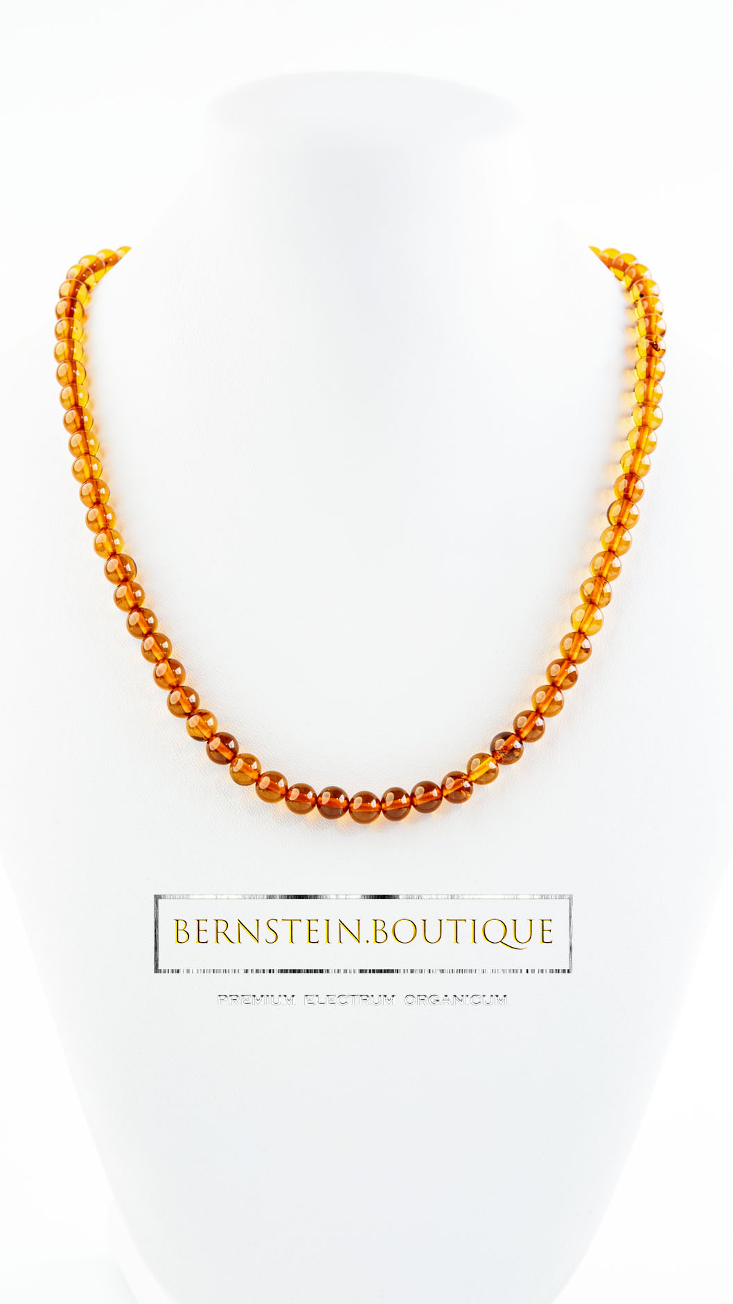 Elegant amber necklace made of round amber beads in natural tones ranging from honey to nut