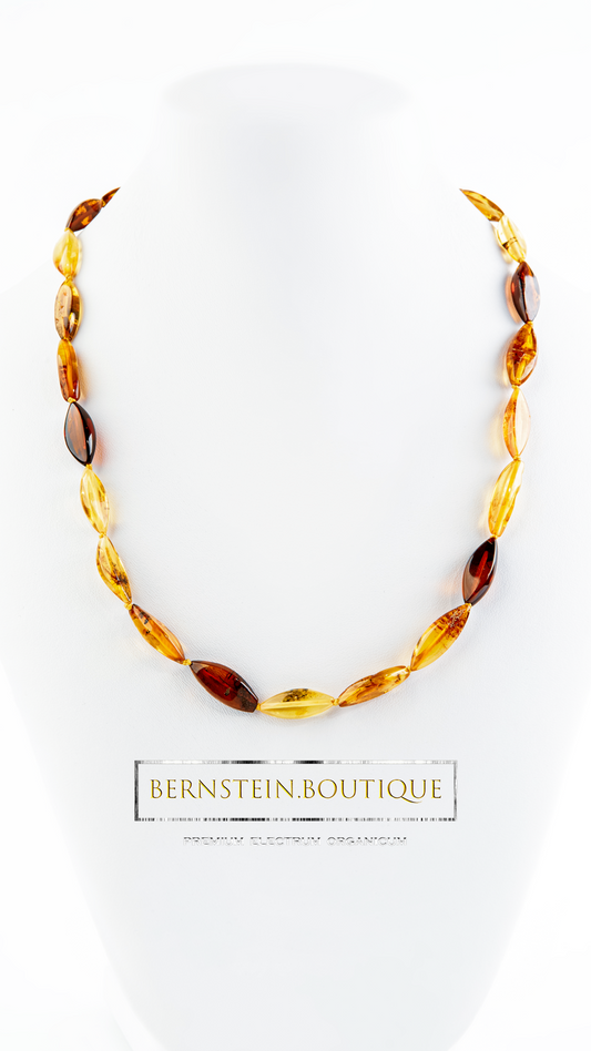 Amber necklace made of elongated chaff shapes in all color facets of honey