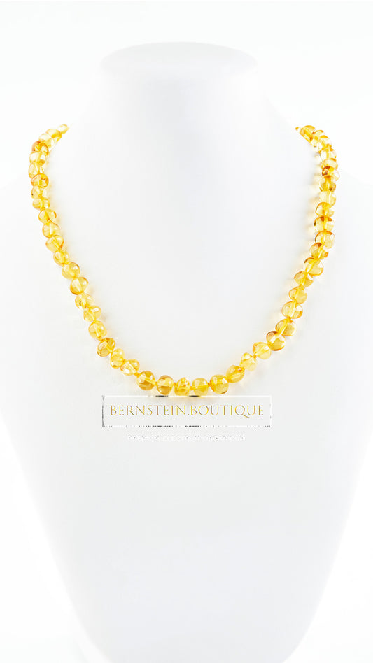 Necklace made of shiny polished small baroque amber beads