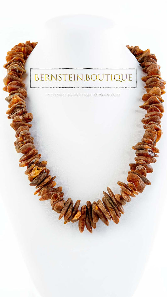 Necklace made of raw natural amber in noble shades of red, unpolished splinter pearls