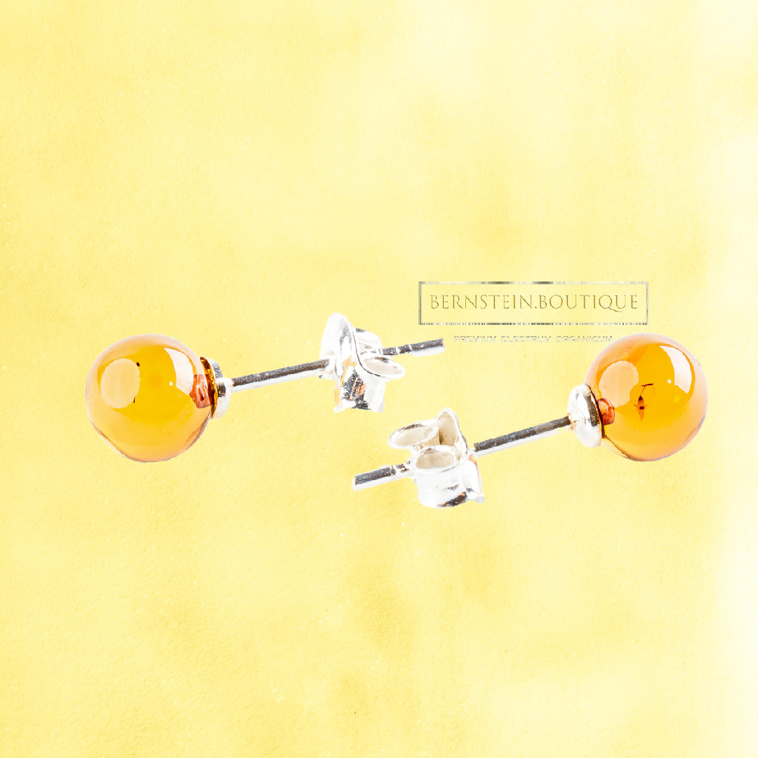 Stud earrings made of two shiny yellow balls made of natural Nordic Amber, ..