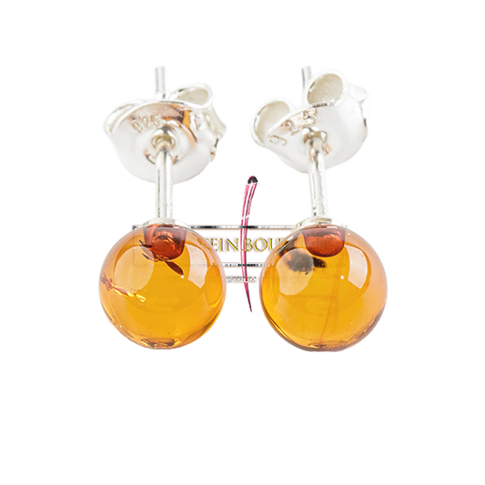 Shiny, partially transparent stud earrings with honey-gold to orange peel amber beads