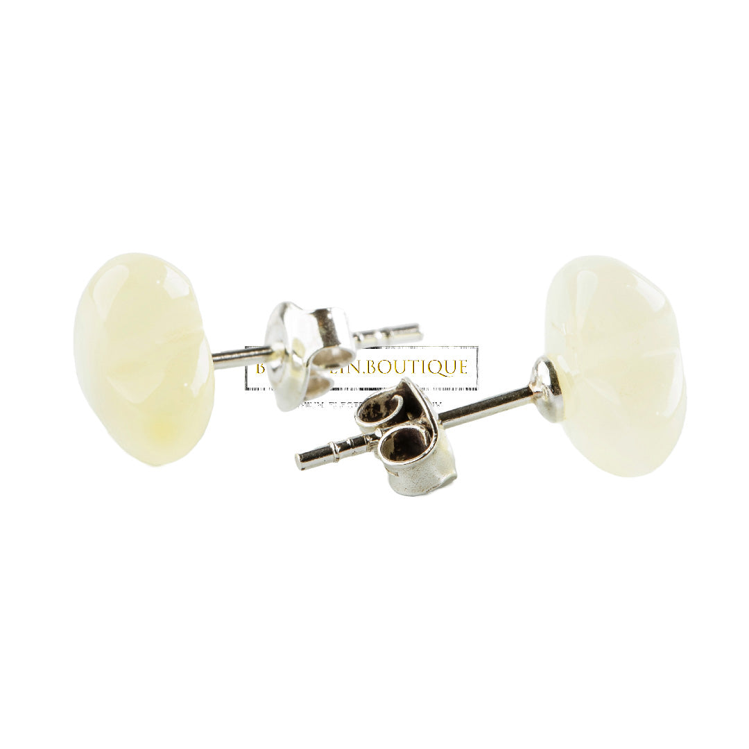 Stud earrings made of butter white amber hearts on sterling silver. 925