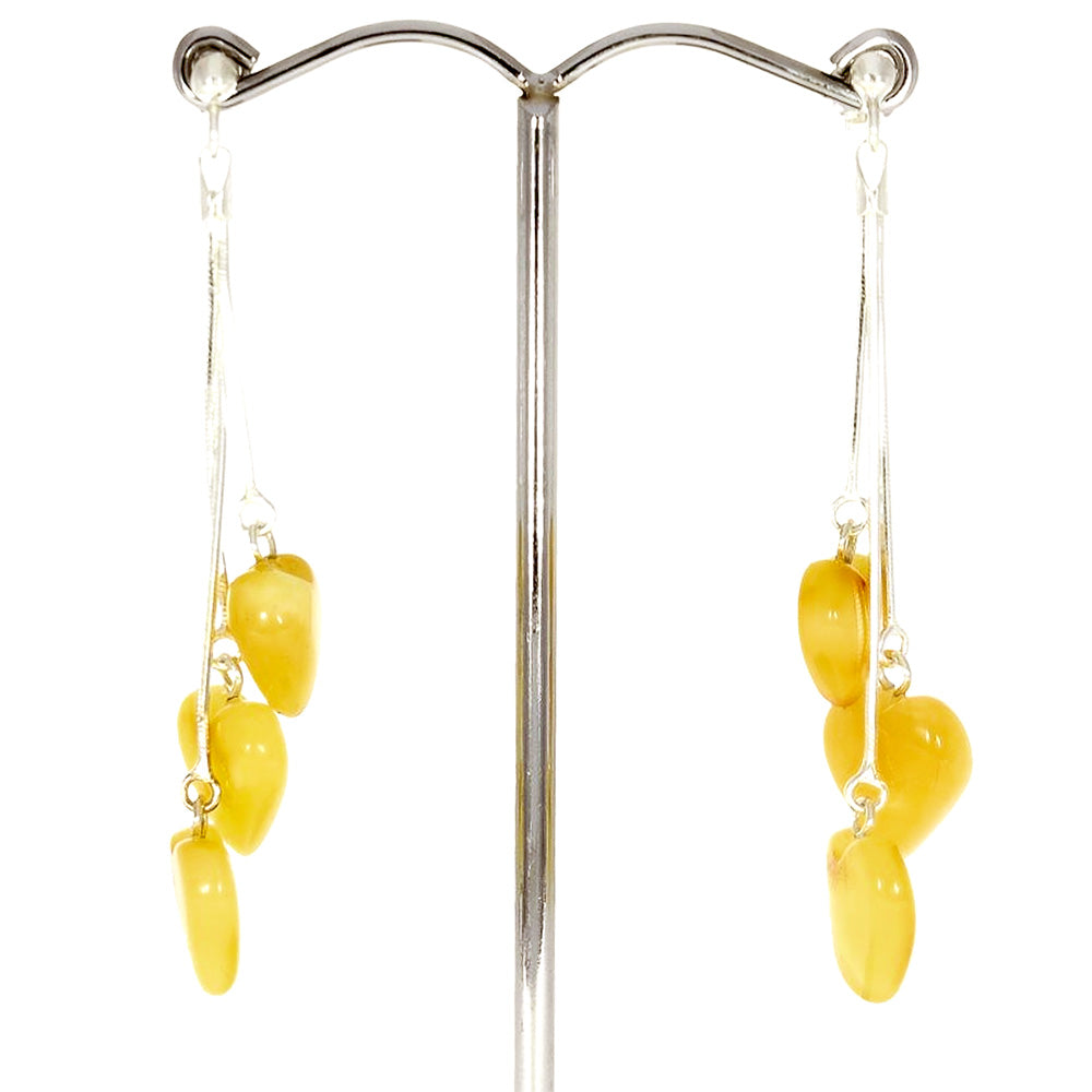 Stud earrings on a silver chain, each with three hearts made of amber - in natural shades of canary yellow