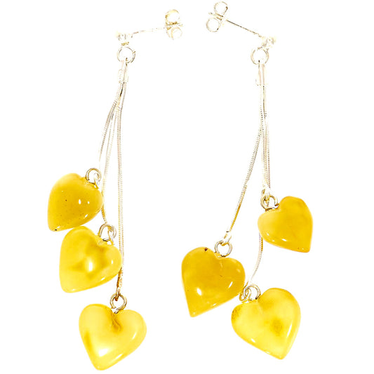 Stud earrings on a silver chain, each with three hearts made of amber - in natural shades of canary yellow