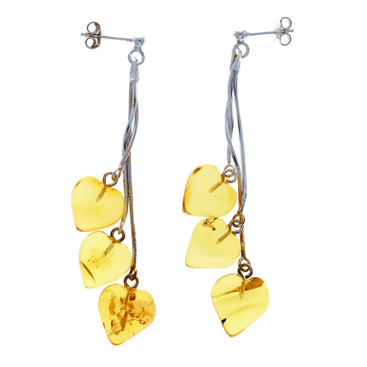 Ear studs on silver chains, each with three amber beads - in their natural color canary yellow