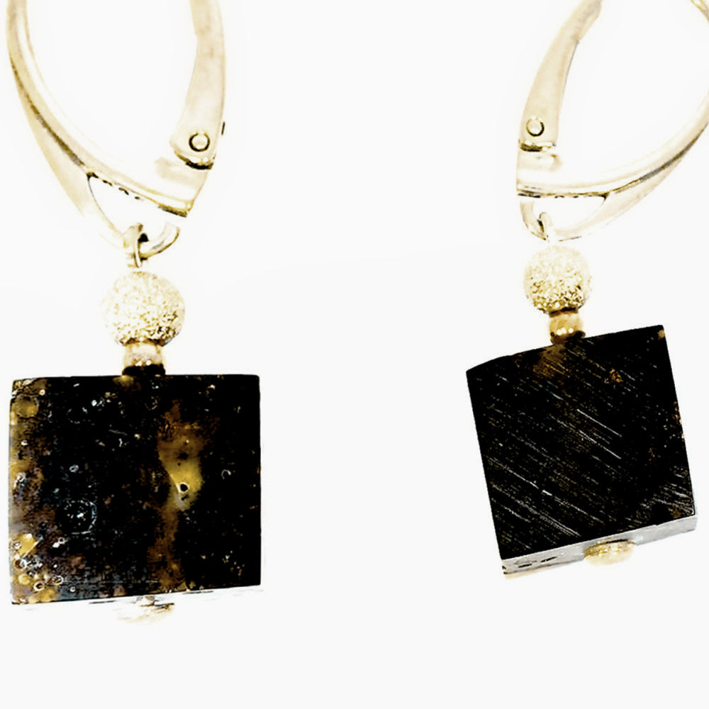 Earrings adorned with cubic, smooth-cut amber beads on sterling silver