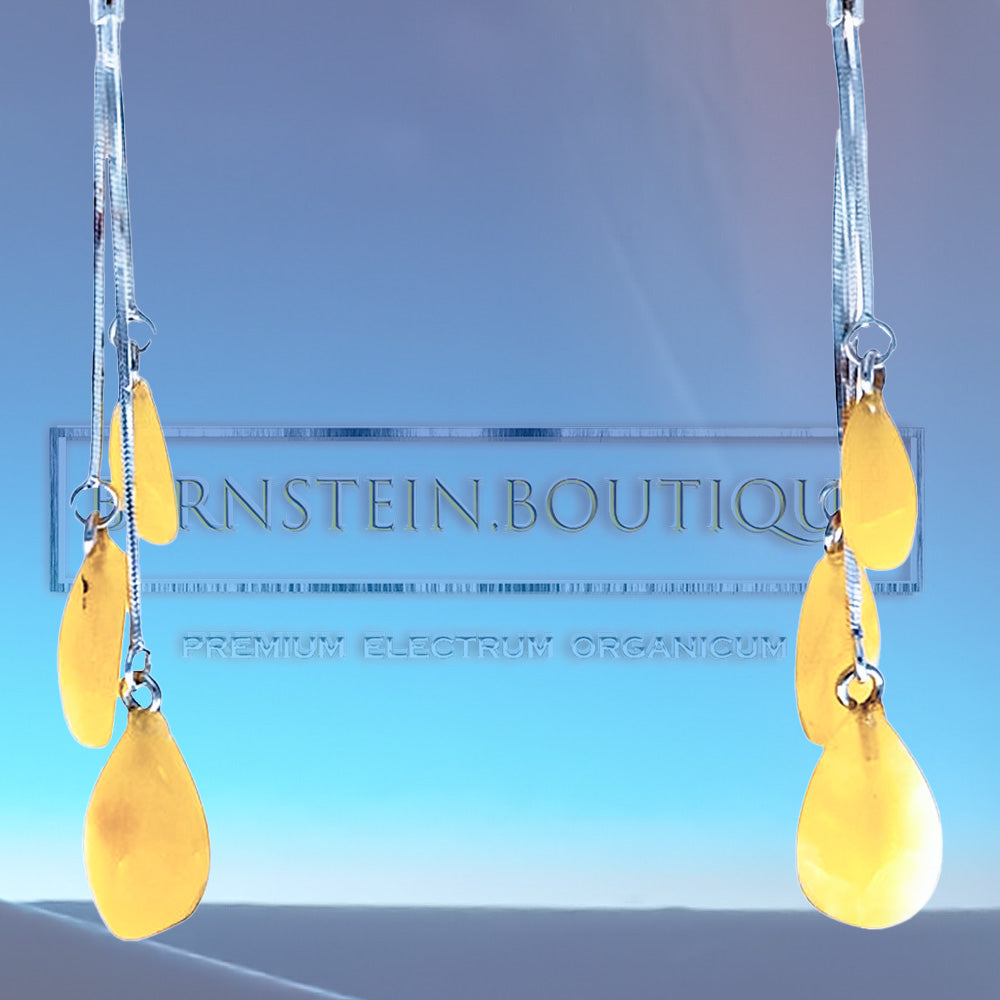 Stud earrings made of sterling silver .925 with three amber beads each hanging on a silver chain