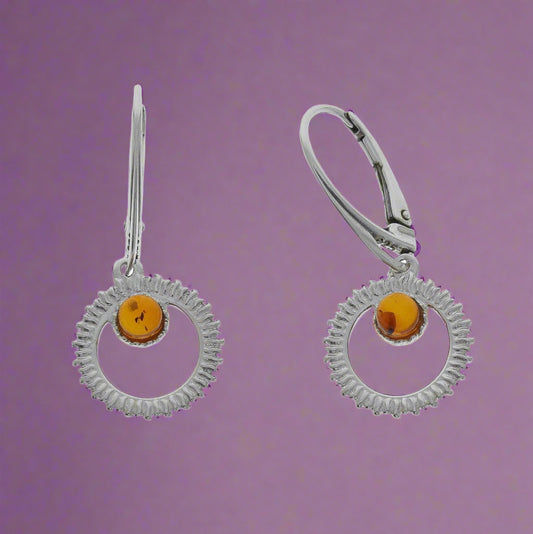 Sterling Silver 925 Earrings with Nordic Natural Amber

These exquisite earrings are fashioned from the finest 925 Sterling Silver and artfully adorned with Nordic natural amber—a truly singular organic gemstone. Each individual amber piece is unique, its captivating colour and distinctive pattern ever shifting within the play of light. The handcrafted settings serve to accentuate the inherent beauty of this material, known as the "burning stone," thereby bestowing upon your visage an aura of  elegance.