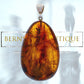 Oval and transparent pendant made of amber