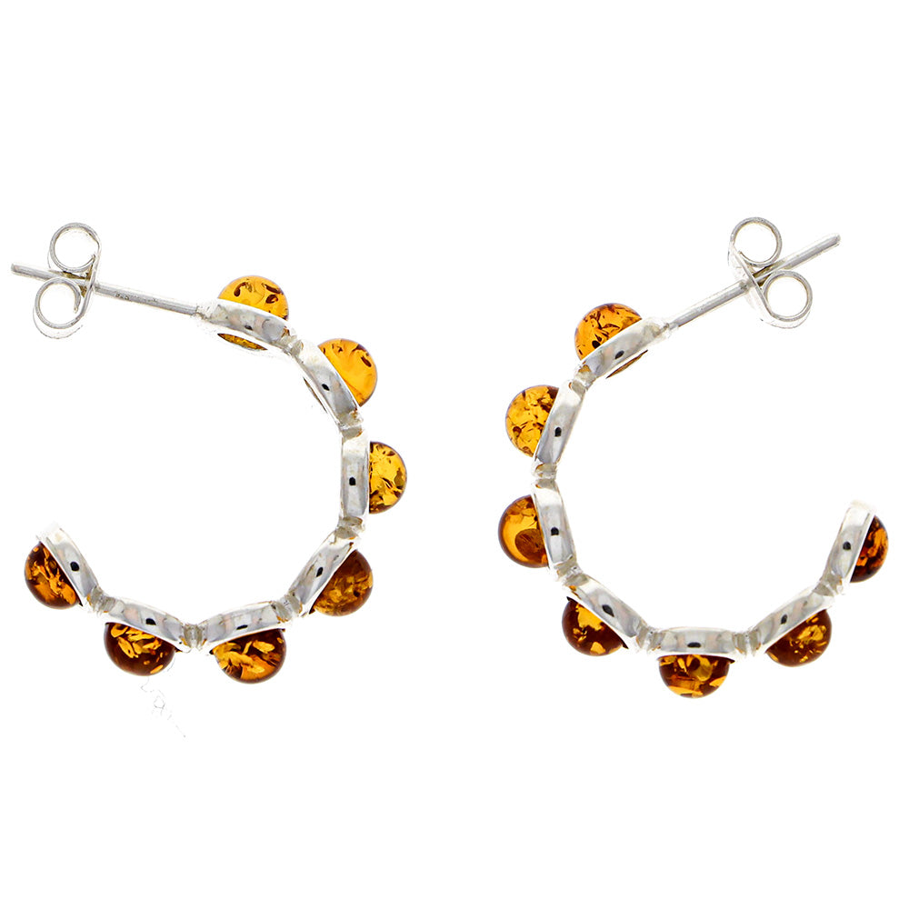 Ear studs made of sterling silver, each with six "beads" made of natural amber