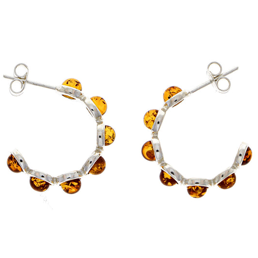 Ear studs made of sterling silver, each with six "beads" made of natural amber