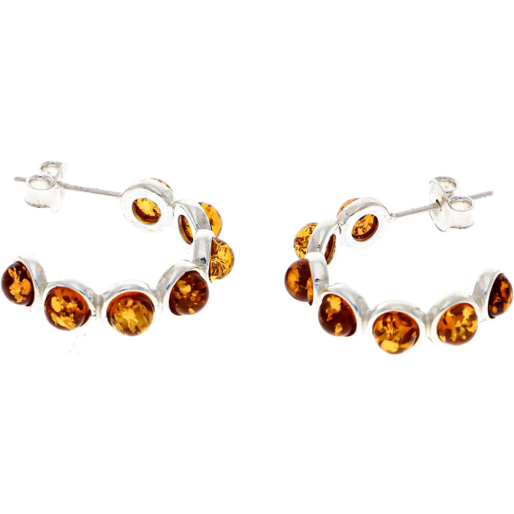 Ear studs made of sterling silver, each with six "beads" made of natural amber