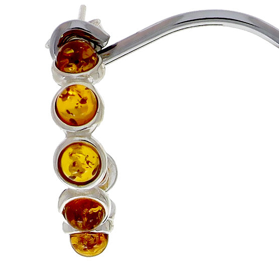 Ear studs made of sterling silver, each with six "beads" made of natural amber