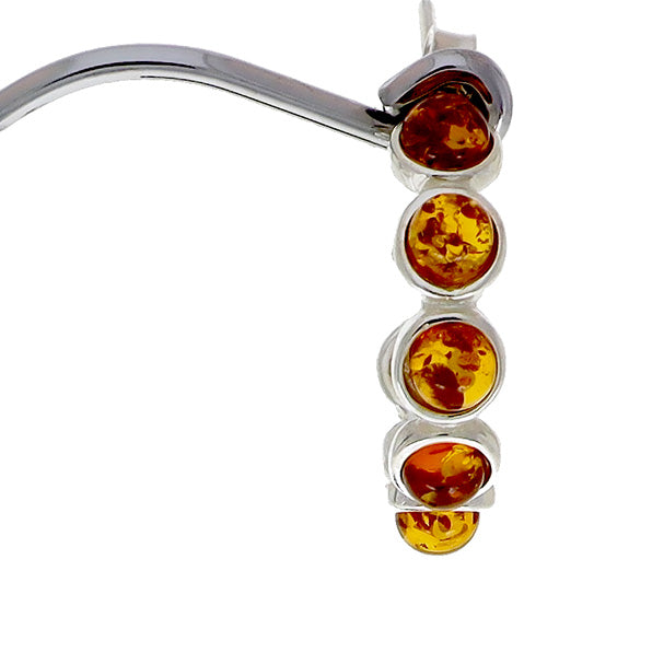 Ear studs made of sterling silver, each with six "beads" made of natural amber