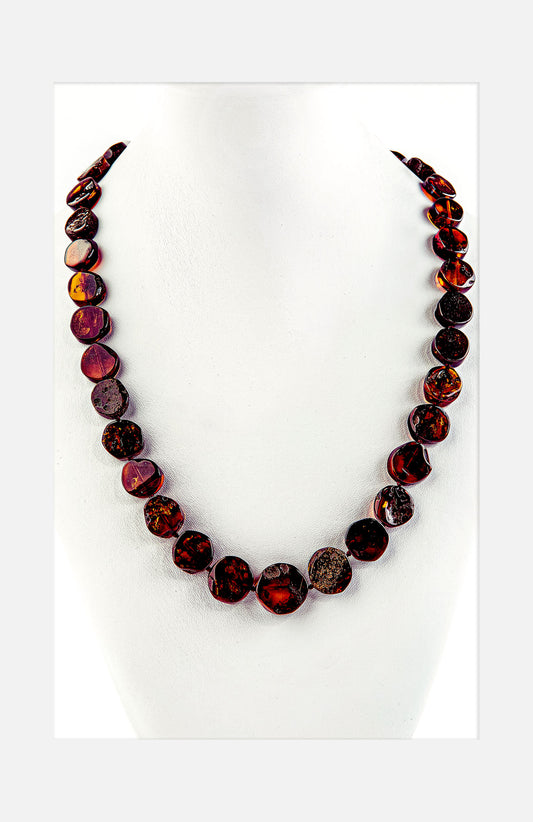 Necklace made of shiny polished discs in natural amber red